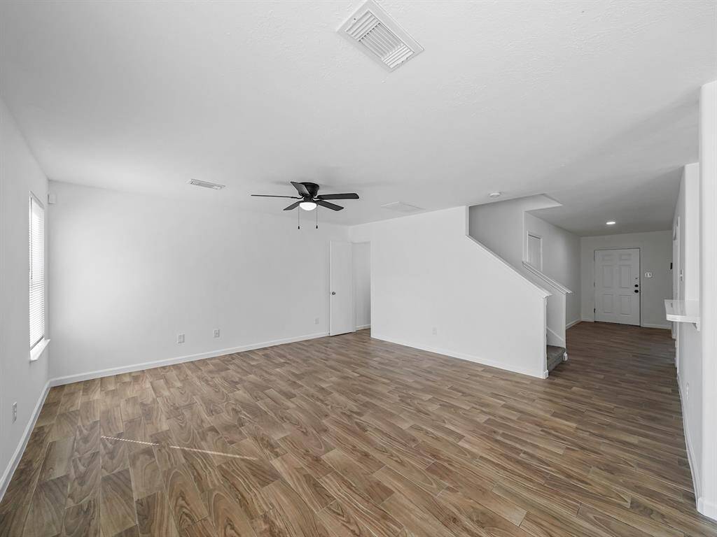 This expansive living room offers plenty of space for larger furniture, creating an inviting atmosphere for relaxation and entertainment.