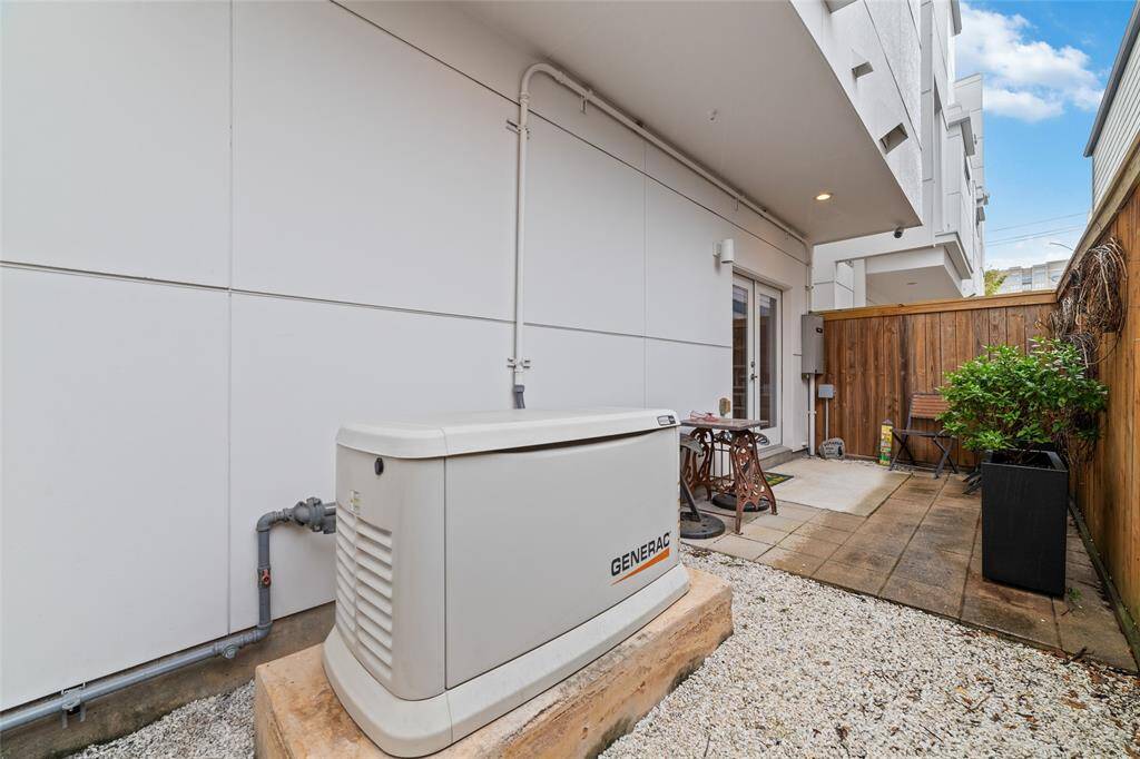 The private patio right off the bedroom/office is where you’ll find the Generac generator discreetly situated. There are two entrances to the back private patio. A custom gated door at the front of the home provides additional access to the backyard and patio.