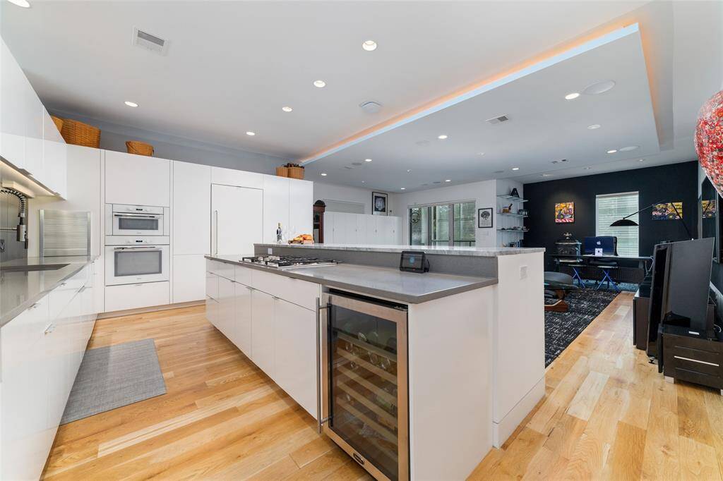 The expansive walk-in pantry, with a stylish glass door, showcases a stunning redwood wine display and a sleek horizontal wine rack, capable of holding up to 144 bottles of your favorite wine!