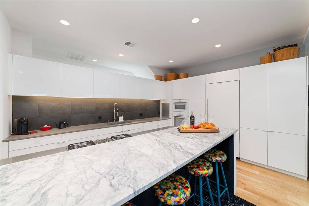 The stunning Carrara marble countertop island is sure to become the heart of the home.