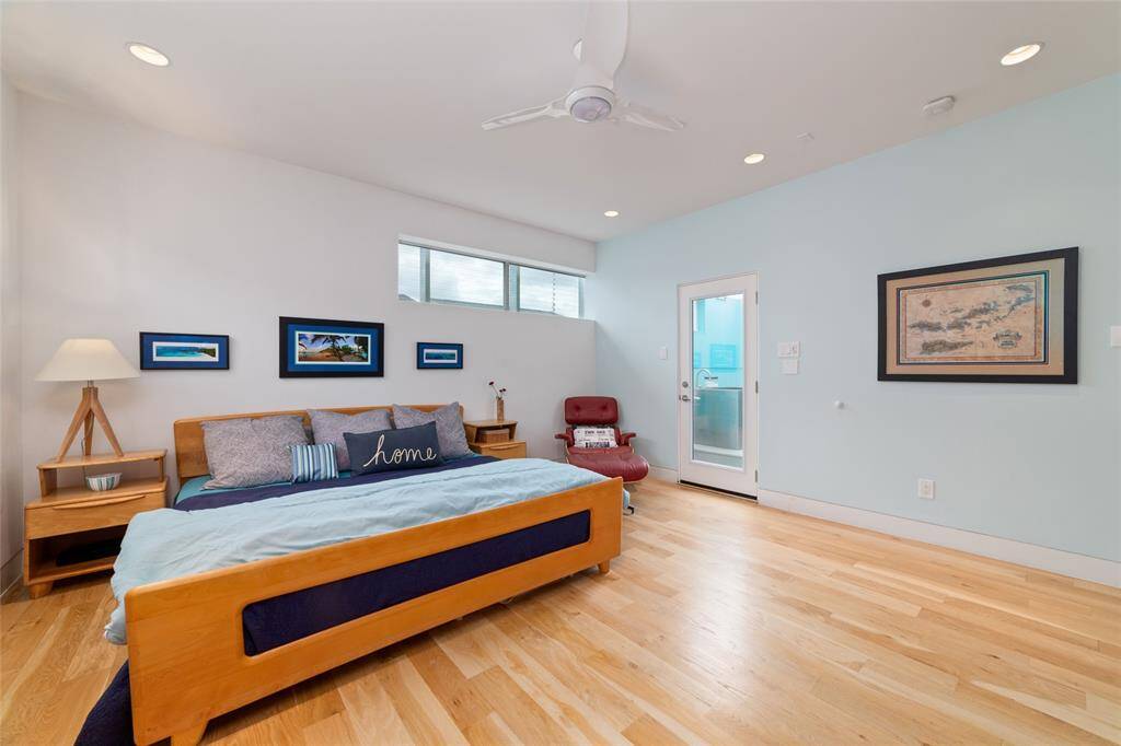 Sleek primary suite with a door leading to the Japanese soaking tub. Let the light pour in.
