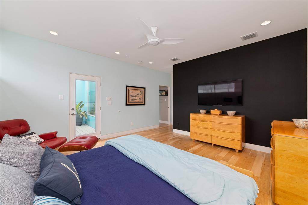 Door on the left leads to the Japanese soaking tub. The door on the right leads to the ensuite primary bathroom. The TV will convey with the home.
