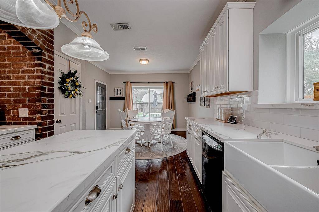 Great lighting, subway tile backsplash, designer hardware along with dishwasher make this space pretty and functional.