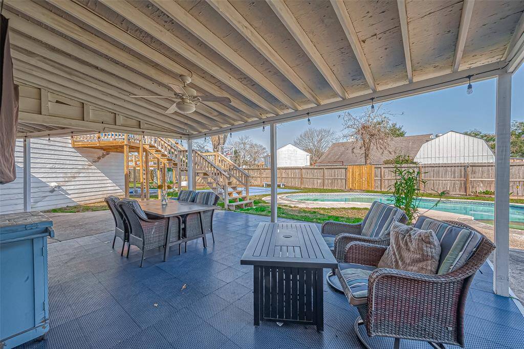 Delightful covered patio with television and seating perfect for watching your favorite game & chilling out.