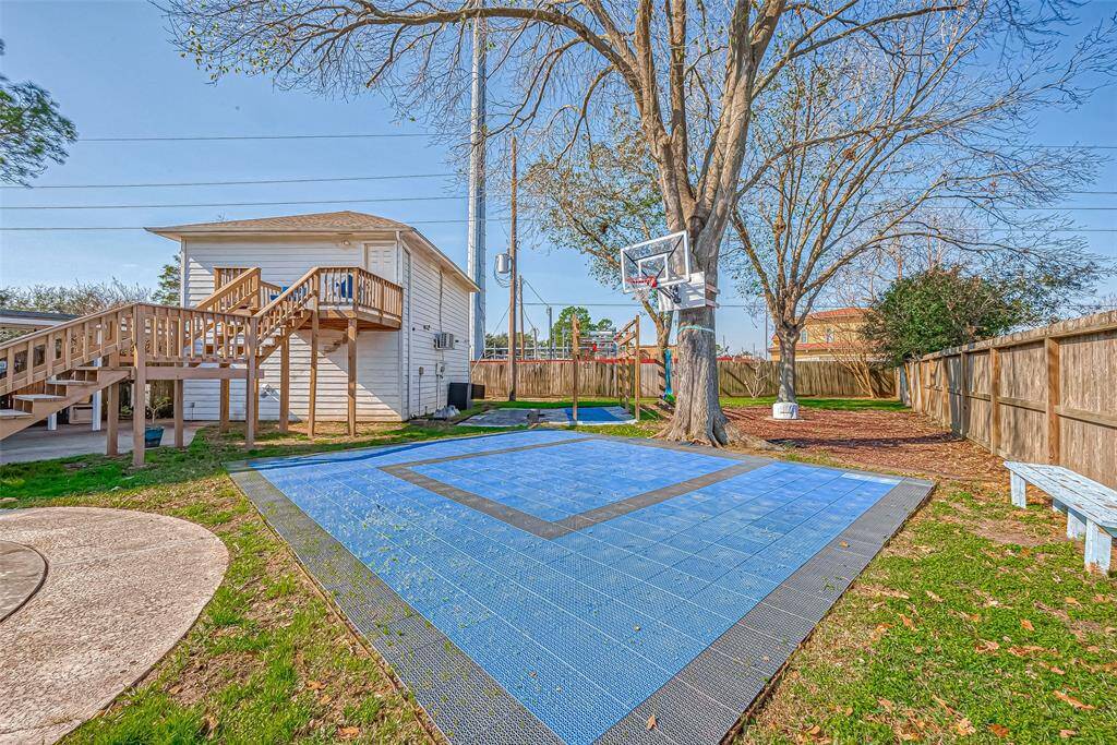 Fantastic sport court with basketball goal awaits play and fun.