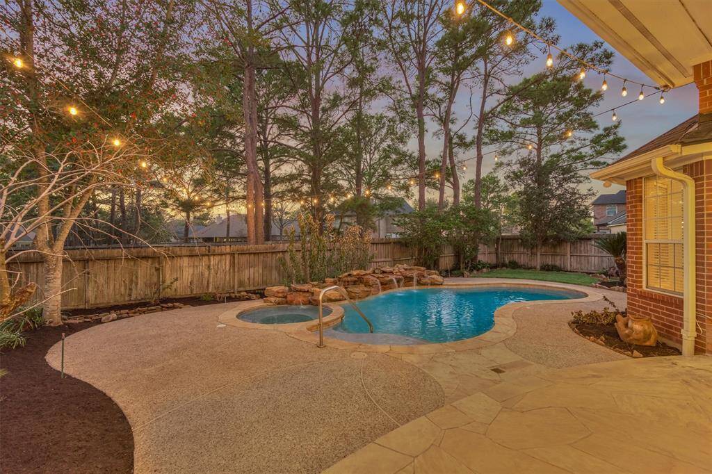 This backyard oasis has a sparkling pool and spa complete with a tranquil rock waterfall and is ready for summer fun!