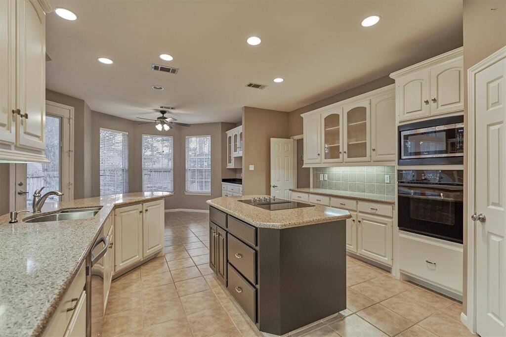 Several glass upper cabinets for displaying special serving ware.