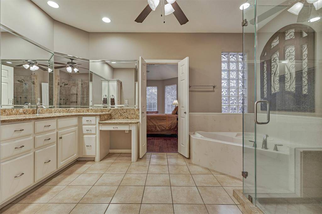 The primary ensuite features a soaking tub with separate shower and dual vanities.