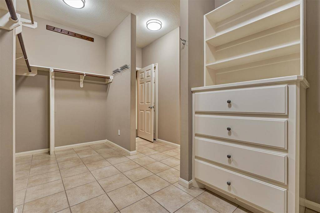 This dreamy primary closet has built-in drawers and shelving for ultimate organization.