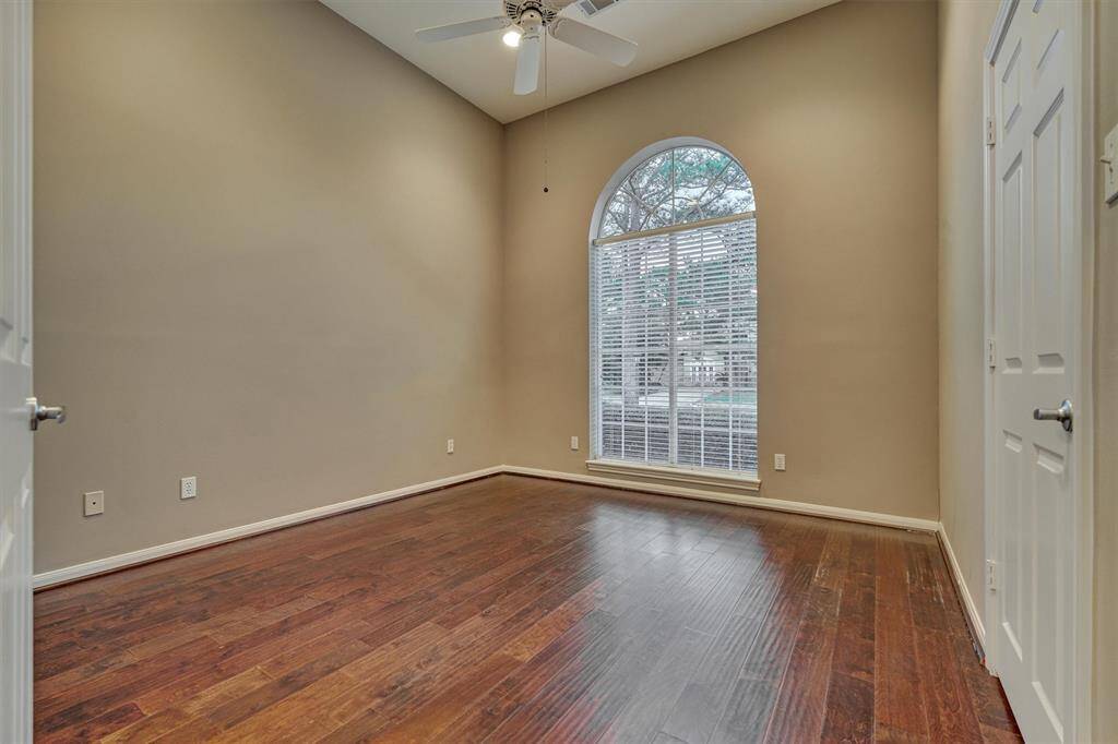 Secondary bedroom #1 enjoys wood flooring, a picture window boasting with natural light and front yard views.