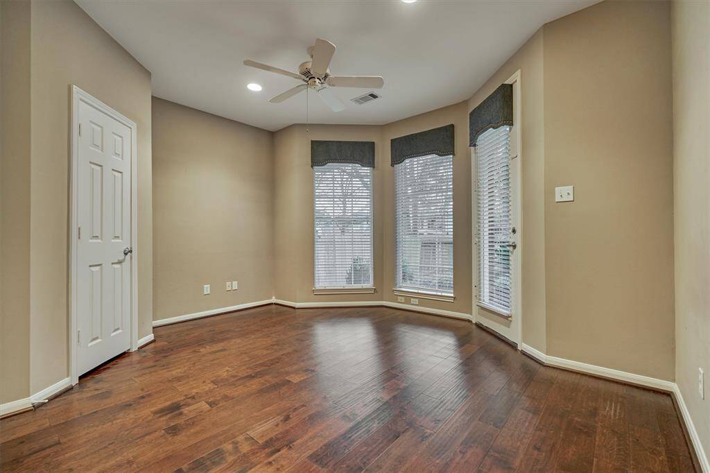 Secondary bedroom #2 enjoys hard wood flooring, natural light and tranquil views of the back yard.