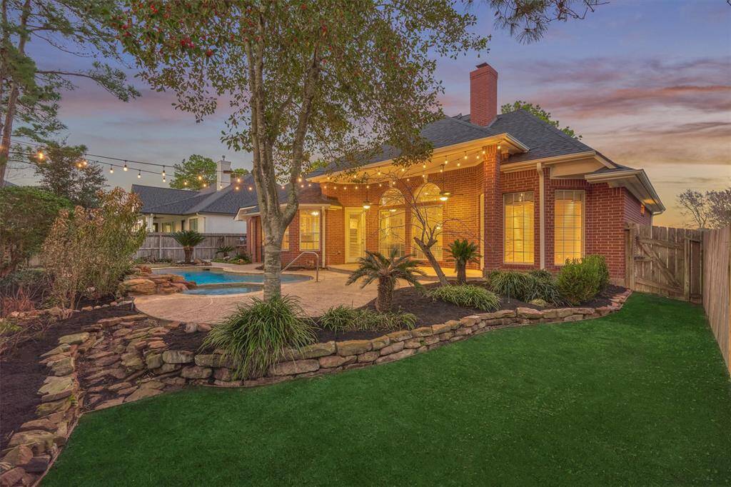 Your backyard paradise is outlined with meticulous rock landscaping and freshly mulched beds.
