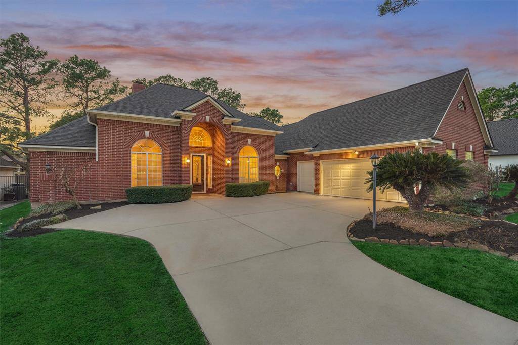 2-car garage with golf cart bay and an extended driveway for guest parking.
