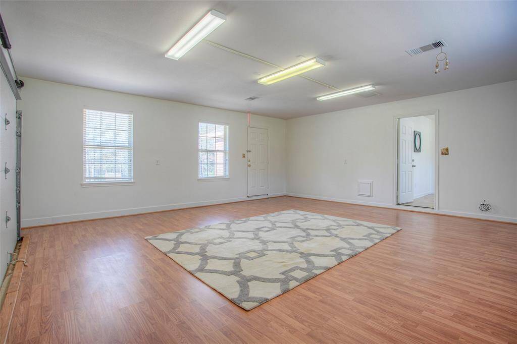 Garage converted into a flex space/room. shiplapped walls would look great where garage door is or can be change back to a garage.