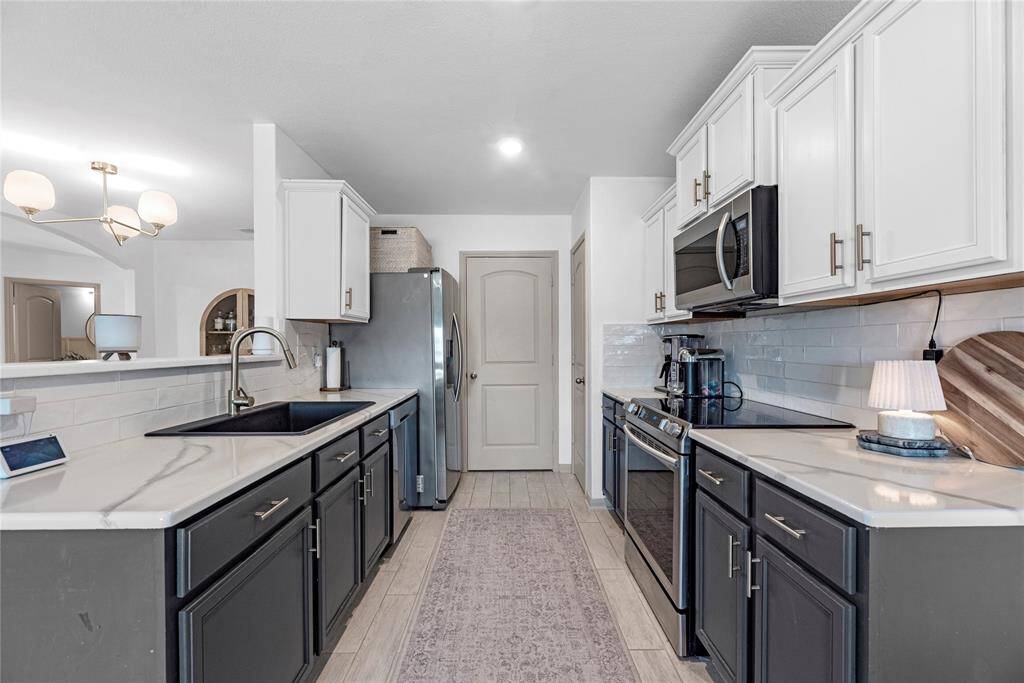 A modern kitchen with sleek countertops, stainless steel appliances, and plenty of space to cook and entertain.