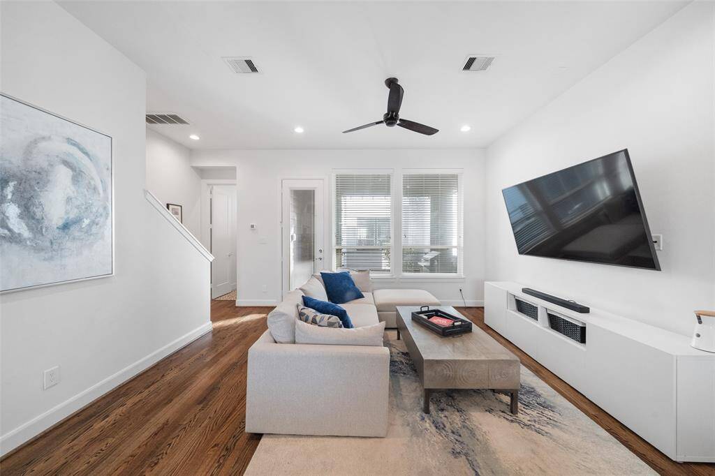 Alternate view of Living area, which features balcony door and half bath.