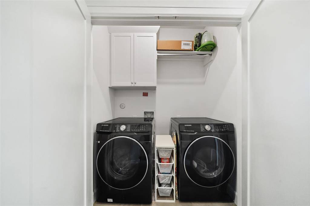 Utility room, featuring cabinet and rod.