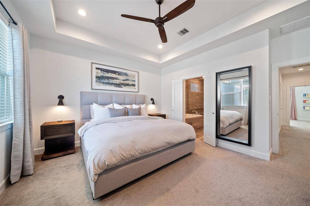 Third Floor Primary Suite features tray ceiling, 2 walk-in closets, and natural light.