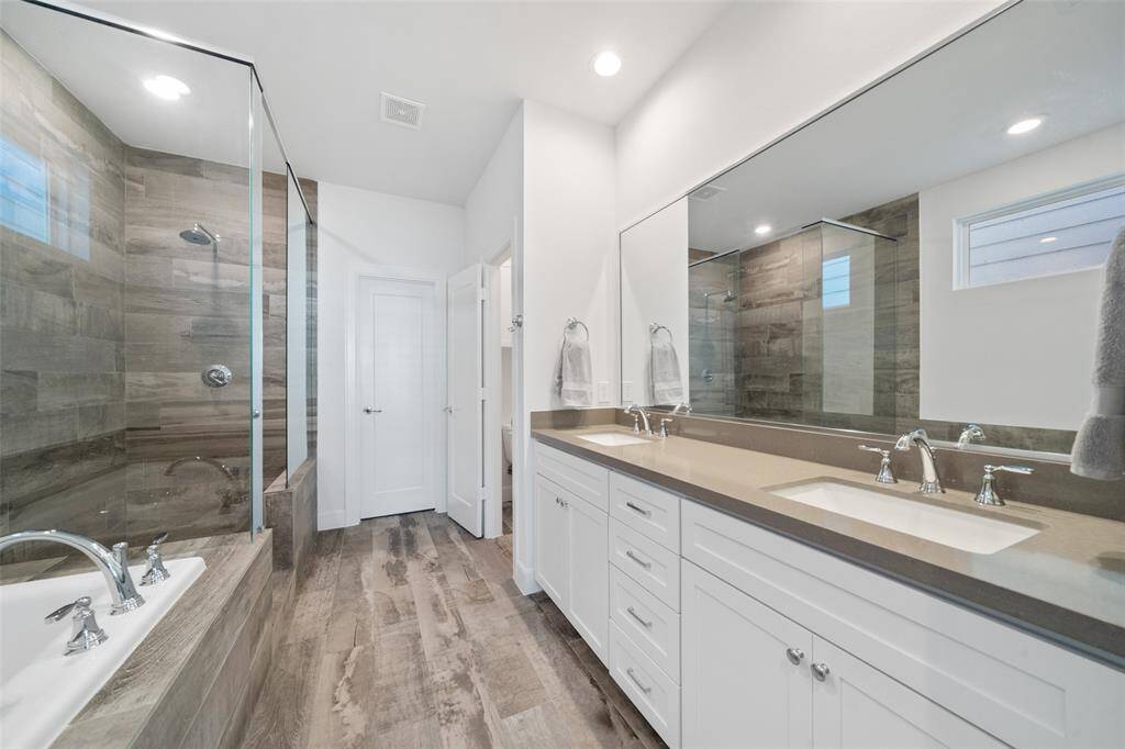 Luxurious Primary Bath features, double sinks, soaking tub, and separate over-sized shower.