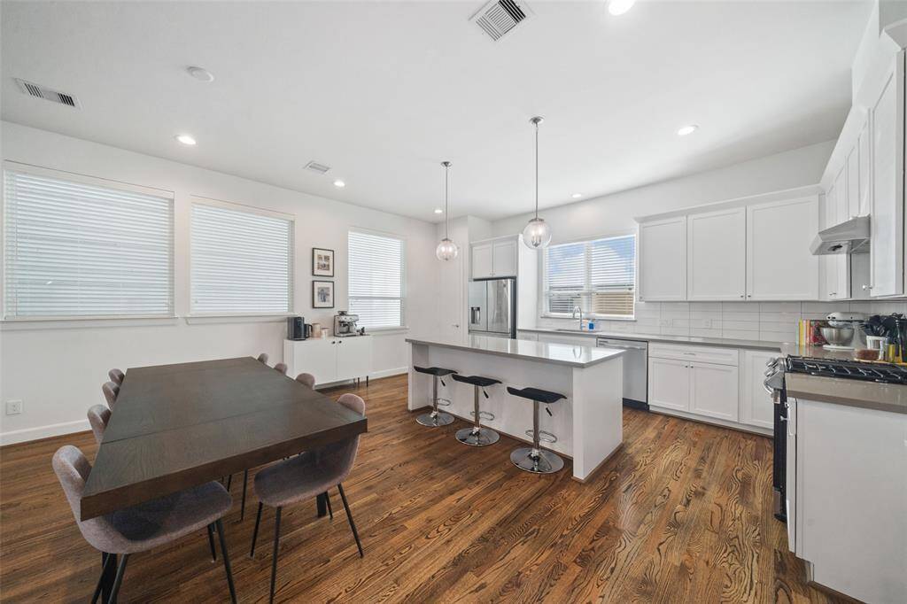 Second floor Living features open floor plan, abundant natural light, hardwood floors, and high ceilings.