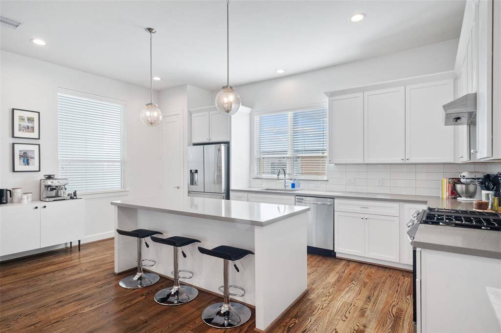 Stunning Kitchen, featuring ample windows and timeless quartz countertops.