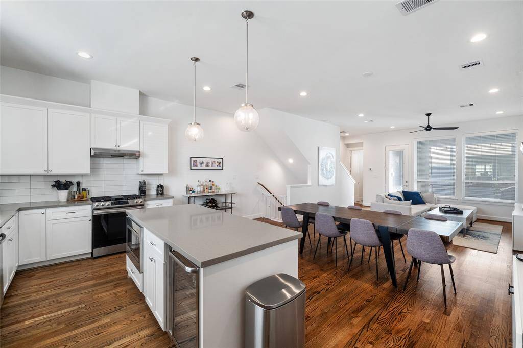 Kitchen Island features wine refrigerator.