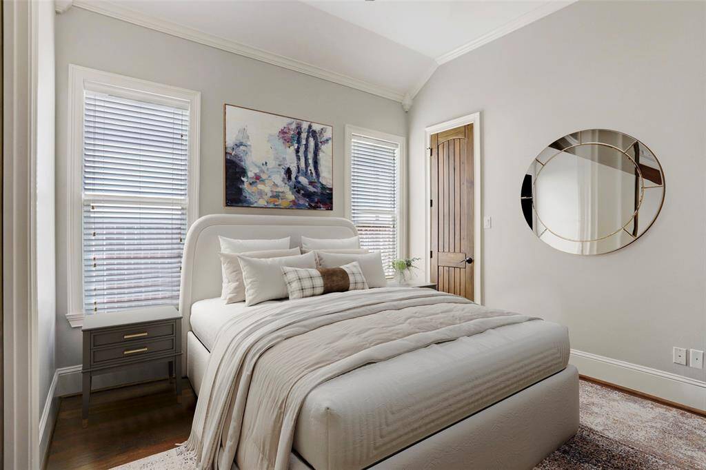 This bright secondary bedroom boasts an airy vaulted ceiling and abundant natural light from two large windows, creating a calm, inviting space. With thoughtful details and a comfortable layout, this room offers a perfect retreat for family or guests. (Digitally Staged)