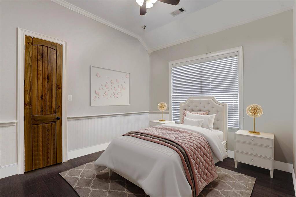 This cozy nursery exudes warmth and charm with its subtle wainscoting, soft pink and white palette. The vaulted ceiling and large window allow natural light to flow in, creating a bright, airy ambiance. It’s a delightful retreat for any little one, seamlessly blending classic design with modern comfort. (Digitally Staged)