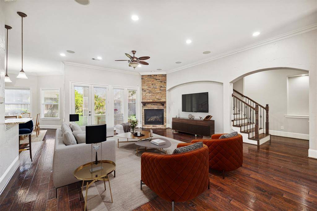 This inviting living area is perfect for both everyday relaxation and entertaining, featuring an open layout, a cozy fireplace, and abundant natural light from the wall of windows overlooking the backyard. As we continue our tour, we’ll make our way up the beautifully crafted staircase to explore the home’s second floor, where a game room, and other bonus spaces await.(Digitally Staged)