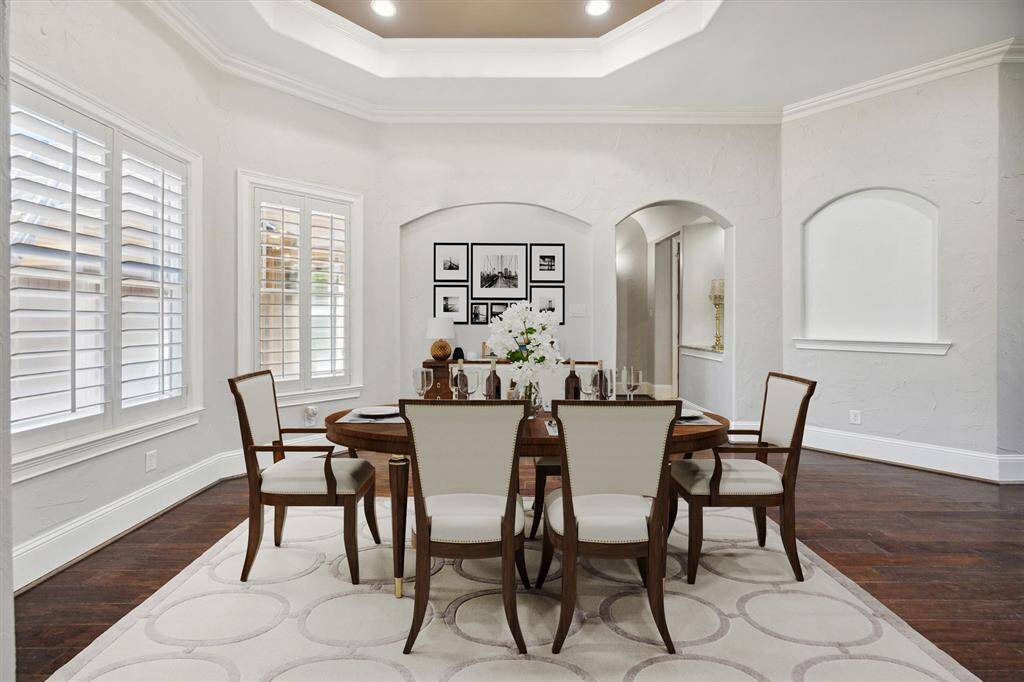 The thoughtfully designed archways provide a seamless flow to the butler’s pantry, powder room, laundry area, and kitchen, ensuring both convenience and style. his space has been virtually staged to showcase its full potential, helping you envision how it can be transformed into the perfect setting for entertaining guests or enjoying intimate family meals. (Digitally Staged)