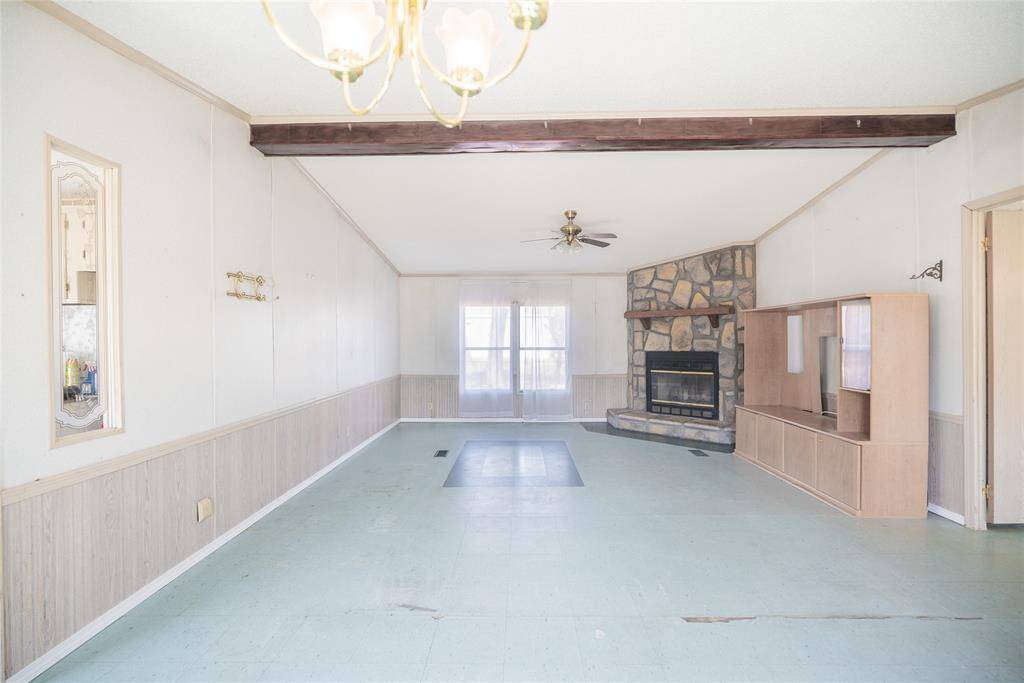 Such a great open family room.  Fireplace, Wood beam and Windows!