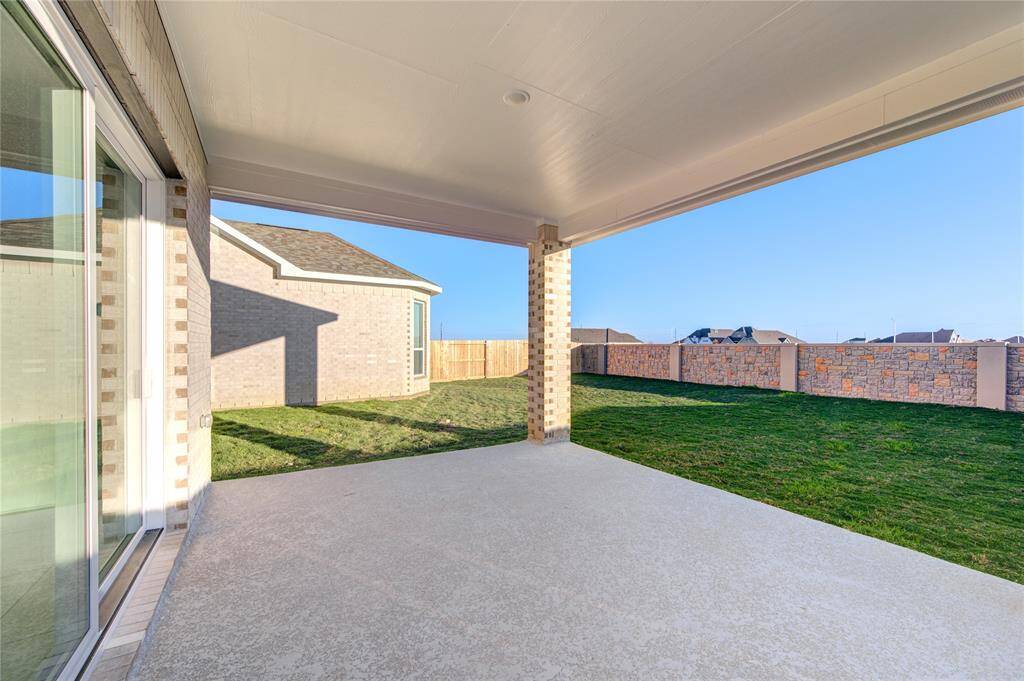 huge covered patio in backyard for family gathering