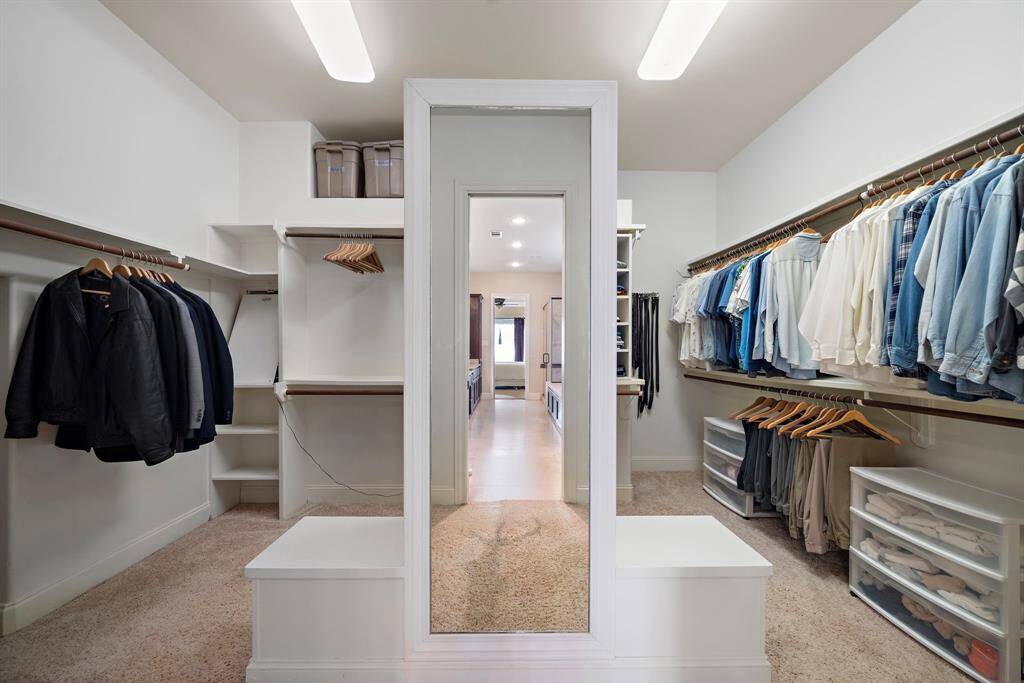 The master bedroom walk-in closet features ample shelving and hanging space for clothing.