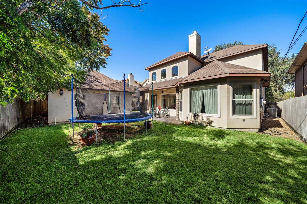 The spacious backyard is perfect for outdoor activities, and a large patio area is ideal for entertaining.