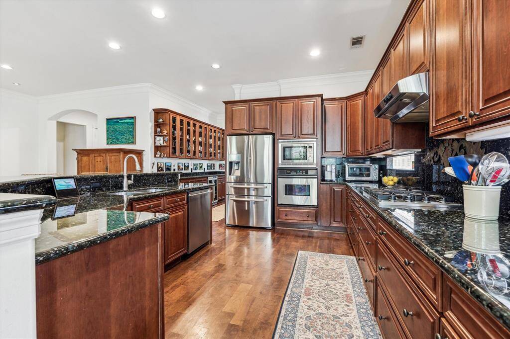 Kitchen has an abundance of storage and stainless appliances.