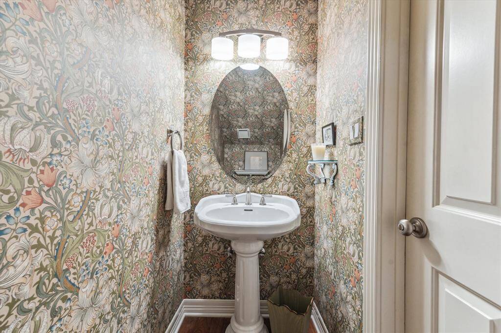 This is a elegant powder room tucked away under the stairs.
