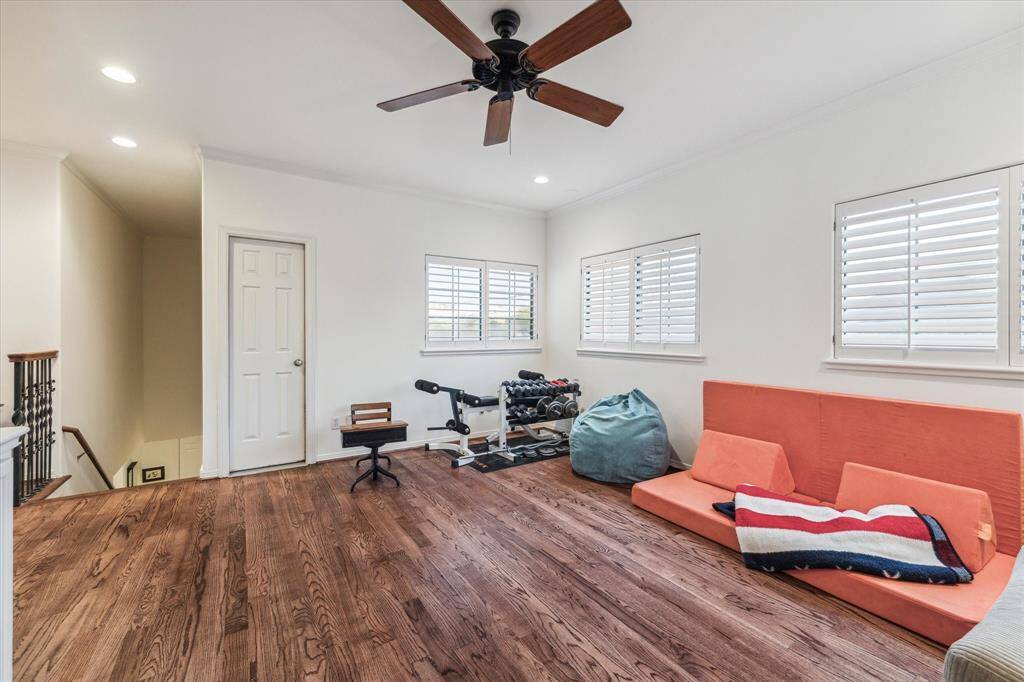 The 2nd floor game room features red oak floors, natural light from all the windows with plantation shutters. This is a versatile room that can serve as a home gym, game room, or multi-purpose area.