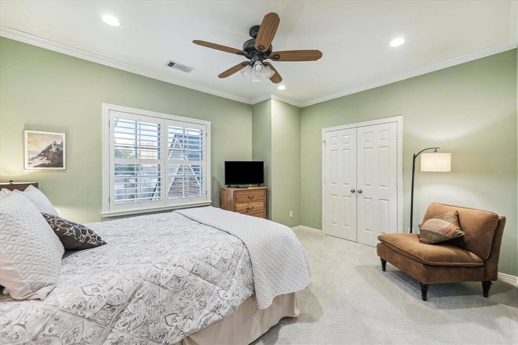 This spacious bedroom features a large windows with plantation shutters and an ensuite.  It also has a very large walk-in closet.