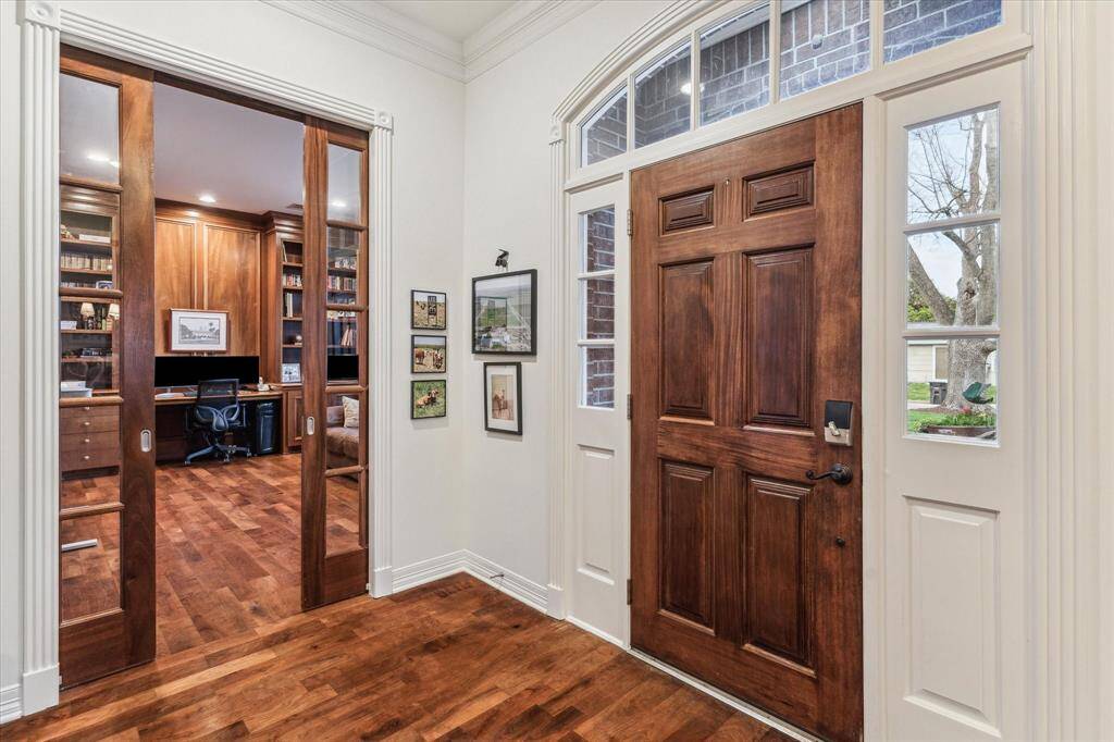 Elegant foyer with a glimpse into the office with sliding pocket french doors.