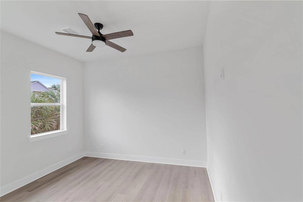 Secondary bedroom on the first floor with a ceiling fan and neutral walls ready for your personalization.