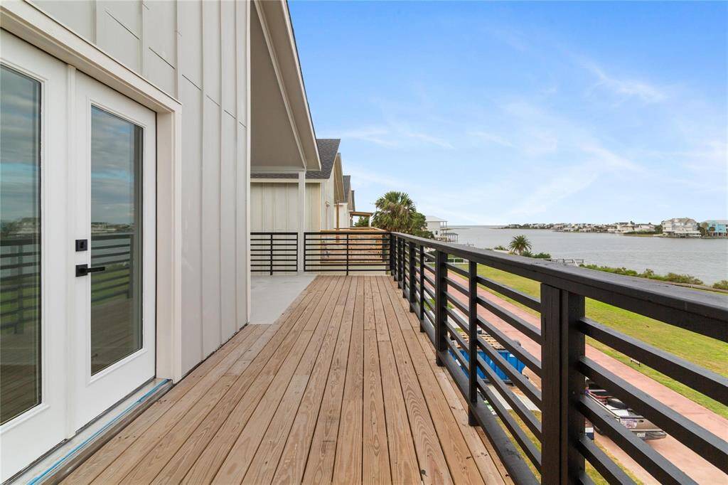 Spacious waterfront deck with a scenic bay view, perfect for relaxation and entertainment.