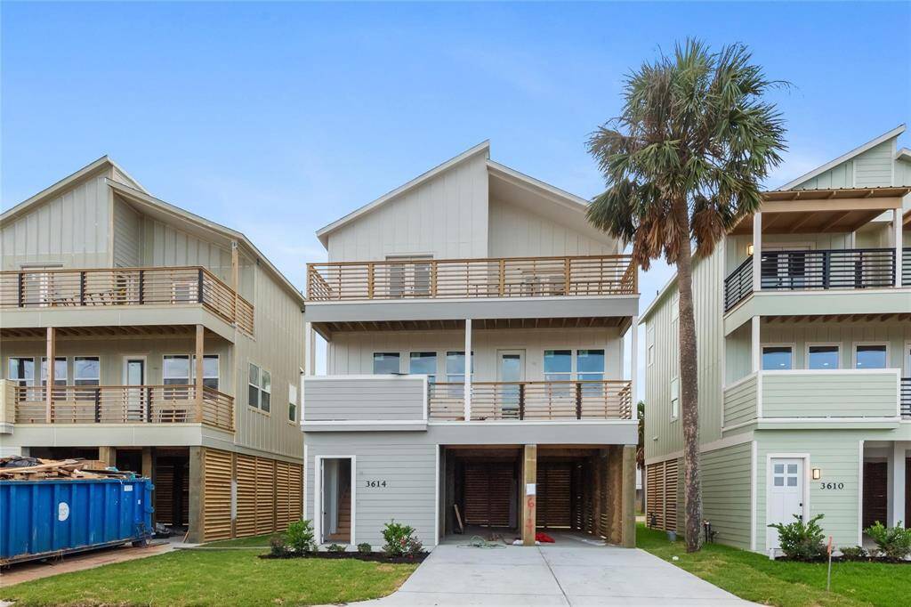 Contemporary homes featuring multiple levels with balconies, large windows, and car parking spaces.
