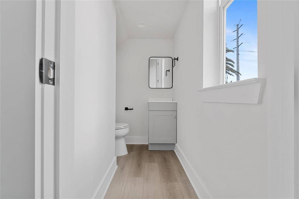 Half bathroom is located on the 1st floor with contemporary finishes and window for natural sunlight.