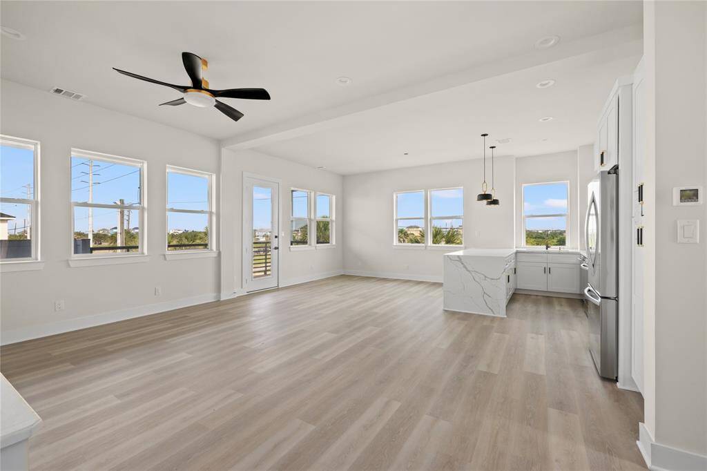 Grand common living area with waterfall quartz countertop in Kitchen