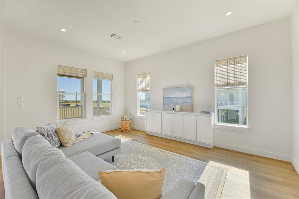Discover the expansive living area, complete with custom built-in cabinetry designed for seamless storage and entertainment. Picture yourself enjoying everyday moments—or setting up your Christmas tree with stunning Gulf views as the backdrop!