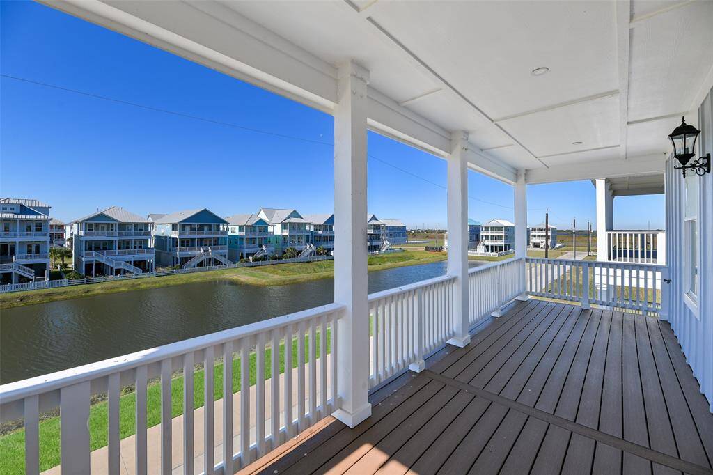 The expansive top floor front deck provides a serene view of the tranquil pond, offering plenty of space to relax, entertain, or simply enjoy the beauty of nature—all with the durability of all-weather decking.
