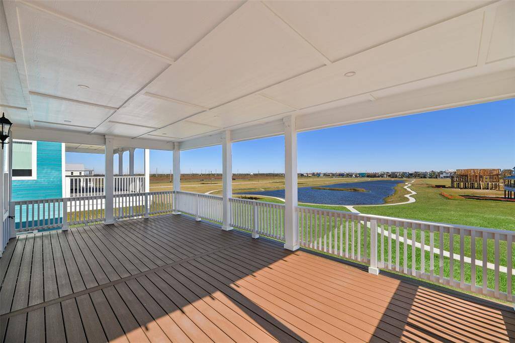 The top floor back deck offers a peaceful escape with enclosed beauty banding, recessed lighting, and breathtaking views of the protected greenspace, tranquil pond, and scenic walking trail—an oasis of serenity.