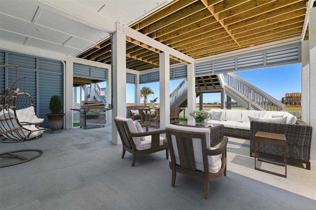 *Virtually staged for illustration purposes only.*The grand dual-sided staircase adds an elegant touch to the home’s exterior, complemented by a beautifully designed low-maintenance yard—perfect for effortless coastal living.