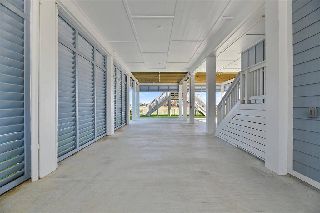 The ground floor features a spacious area perfect for parking all your vehicles- land or seaworthy, an enclosed storage space to secure lock-away items, and a breezeway that seamlessly connects functionality with outdoor living convenience.