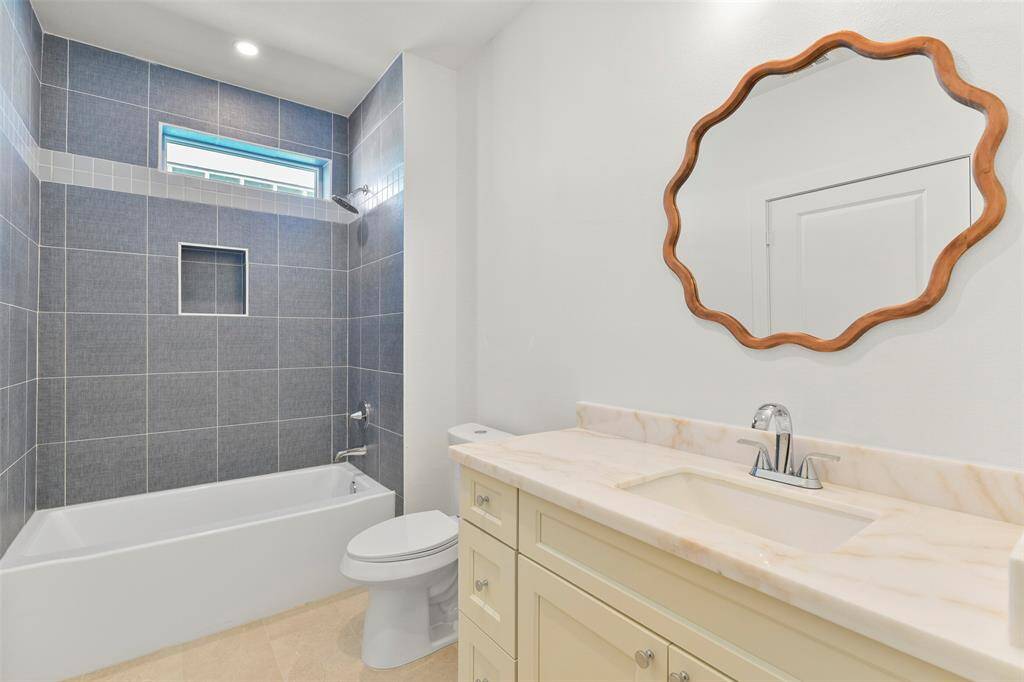 This ensuite bathroom showcases one-of-a-kind designer finishes, adding a touch of elegance and style to the space.